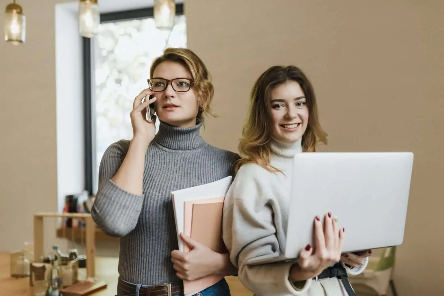 two girls with their laptop and phone